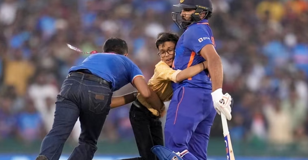 A fan invades pitch to hug Indian captain Rohit Sharma